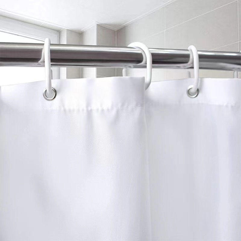 What are the advantages of using a fabric shower curtain over a plastic one?